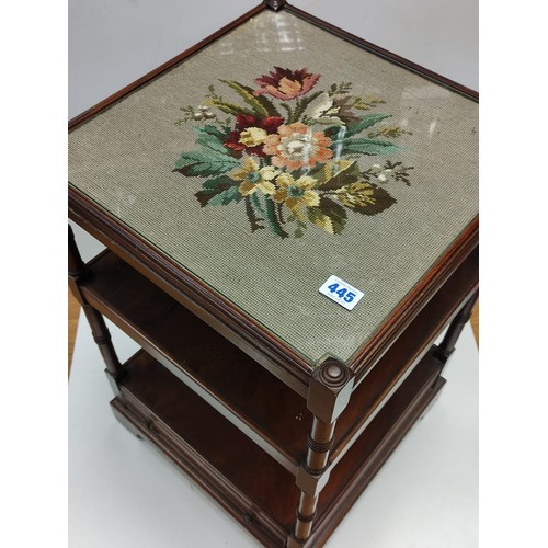 445 - An occasional Table with 2 shelves and bottom draw with an embroidery  under glass top 46 x 46 cm & ... 