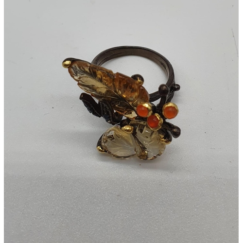 175 - A unique Edwardian silver (unmarked) ring with carved semiprecious and precious stones (citrine, fir... 