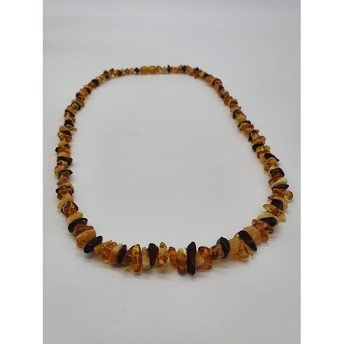 178 - A multicoloured amber necklace and earrings set together with a silver (stamped 925) ring in a prese... 