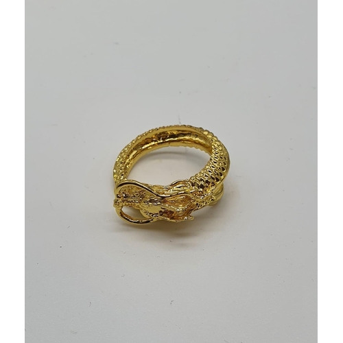 60 - A yellow metal (untested) Chinese dragon ring presented in Faberge style egg.