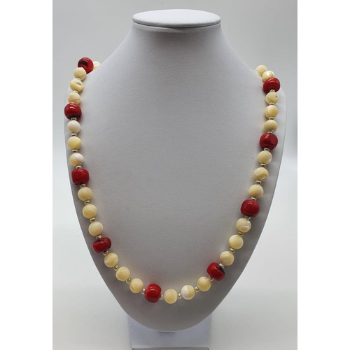 70 - A mother of pearl and red coral necklace and earrings set presented in an unusual Thai, polished, mo... 