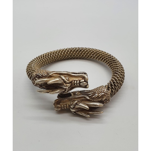 80 - A Tibetan silver bracelet with Chinese Dragon heads. In a presentation box. Although the item is pro... 