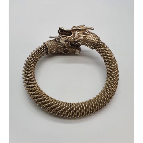 80 - A Tibetan silver bracelet with Chinese Dragon heads. In a presentation box. Although the item is pro... 