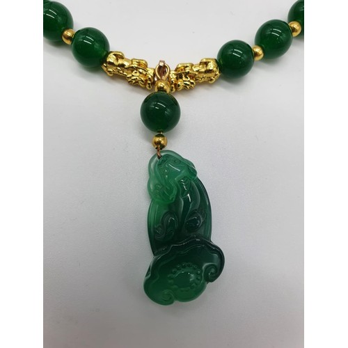 85 - A Chinese green jade and gold plated pixiu necklace and bracelet set in a presentation box. Necklace... 