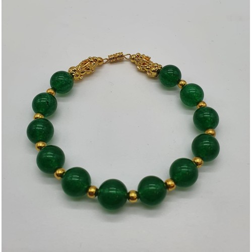 85 - A Chinese green jade and gold plated pixiu necklace and bracelet set in a presentation box. Necklace... 