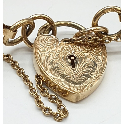 96 - 9ct yellow gate bracelet with heart padlock, weight 26.6g and 19cm long approx