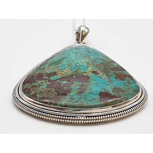 118 - Turquoise marbled stone pendant with silver chain. Length with chain 29cm. Stone Width 4.5cm Height ... 