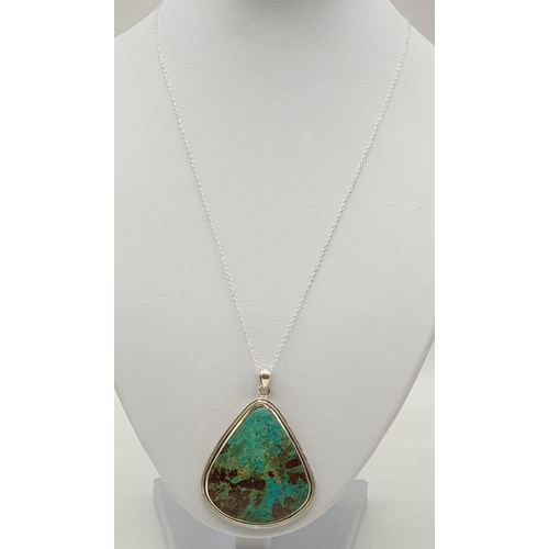 118 - Turquoise marbled stone pendant with silver chain. Length with chain 29cm. Stone Width 4.5cm Height ... 