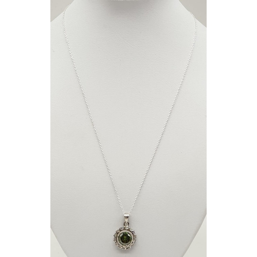 158 - 4ct Green Moissanite pendant in sterling silver. Length 25cm, weight 5g.