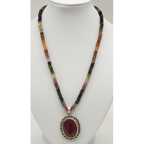 166 - A single strand tourmaline necklace with with ruby pendant in sterling silver. Length 27cm, 45.82g.