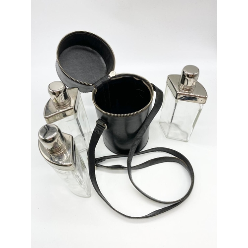 162 - Three glass and chrome hip flasks in leather carrying case.