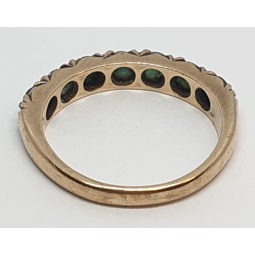 109 - 9ct Yellow gold emerald half eternity ring. Weight 2.8g, Size O.