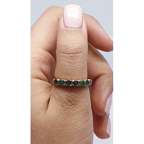 109 - 9ct Yellow gold emerald half eternity ring. Weight 2.8g, Size O.