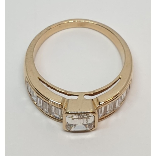 152 - Yellow gold ring with baguette cut diamonds, centre stone 0.85ct and further 0.50ct diamonds on each... 