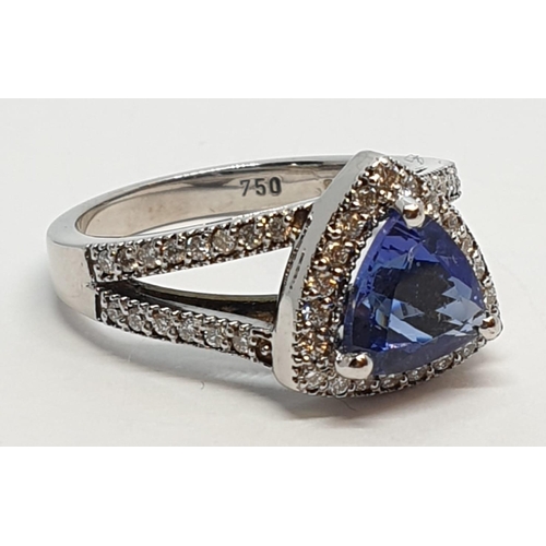 165 - 18CT WHITE GOLD RING WITH TRIANGULAR TANZANITE CENTRE AND DIAMONDS ON SHOULDERS, WEIGHT 7G AND SIZE ... 