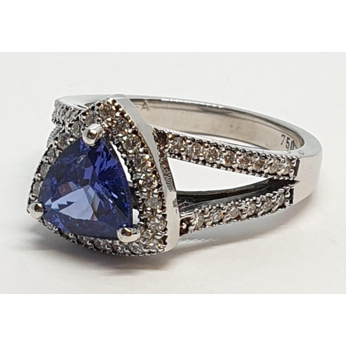 165 - 18CT WHITE GOLD RING WITH TRIANGULAR TANZANITE CENTRE AND DIAMONDS ON SHOULDERS, WEIGHT 7G AND SIZE ... 