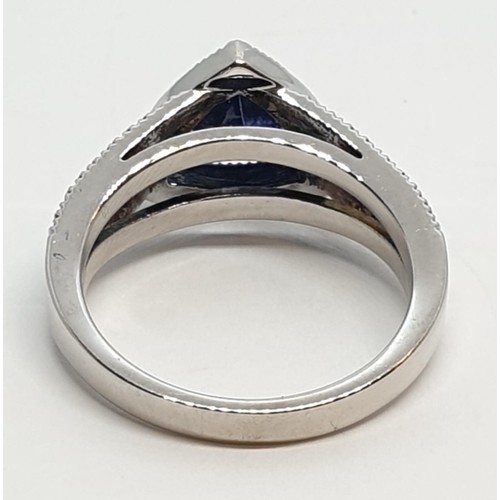 165 - 18CT WHITE GOLD RING WITH TRIANGULAR TANZANITE CENTRE AND DIAMONDS ON SHOULDERS, WEIGHT 7G AND SIZE ... 