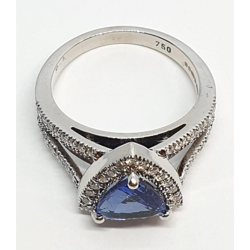 165 - 18CT WHITE GOLD RING WITH TRIANGULAR TANZANITE CENTRE AND DIAMONDS ON SHOULDERS, WEIGHT 7G AND SIZE ... 