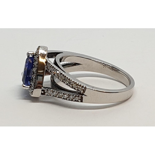 165 - 18CT WHITE GOLD RING WITH TRIANGULAR TANZANITE CENTRE AND DIAMONDS ON SHOULDERS, WEIGHT 7G AND SIZE ... 