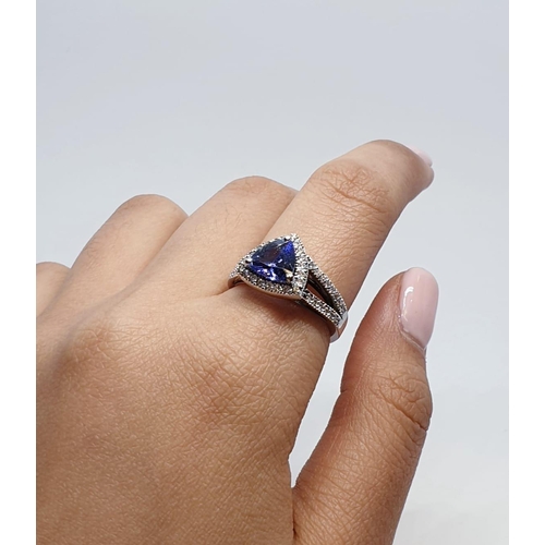 165 - 18CT WHITE GOLD RING WITH TRIANGULAR TANZANITE CENTRE AND DIAMONDS ON SHOULDERS, WEIGHT 7G AND SIZE ... 