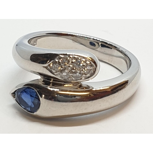 170 - Platinum cross over ring with 0.60ct Thai sapphire and 0.30ct encrusted diamonds, weight 13.7g and s... 