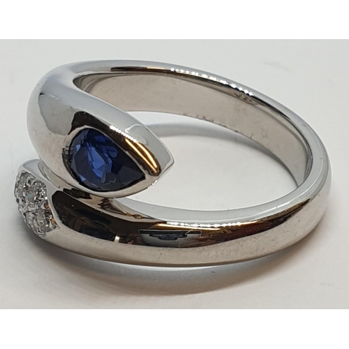 170 - Platinum cross over ring with 0.60ct Thai sapphire and 0.30ct encrusted diamonds, weight 13.7g and s... 