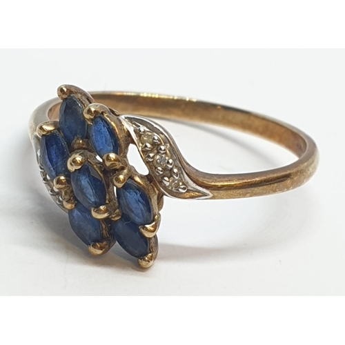 173 - 9ct Yellow gold diamond and sapphire cluster twist ring. Weight 2.2g, Size S.