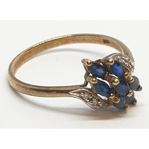 173 - 9ct Yellow gold diamond and sapphire cluster twist ring. Weight 2.2g, Size S.