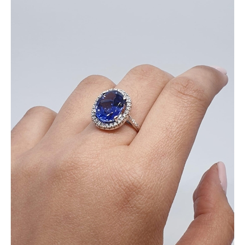 222 - 18ct white gold ring with 4ct tanzanite centre and encrusted diamond surrounding, weight 5.2g and si... 