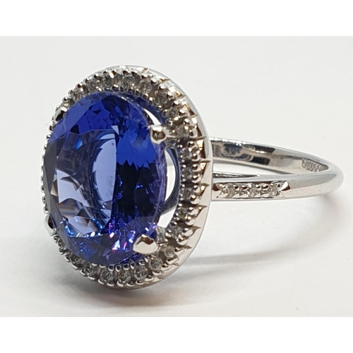 222 - 18ct white gold ring with 4ct tanzanite centre and encrusted diamond surrounding, weight 5.2g and si... 