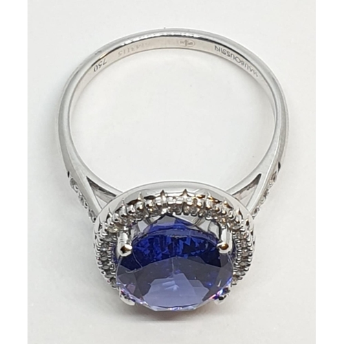 222 - 18ct white gold ring with 4ct tanzanite centre and encrusted diamond surrounding, weight 5.2g and si... 