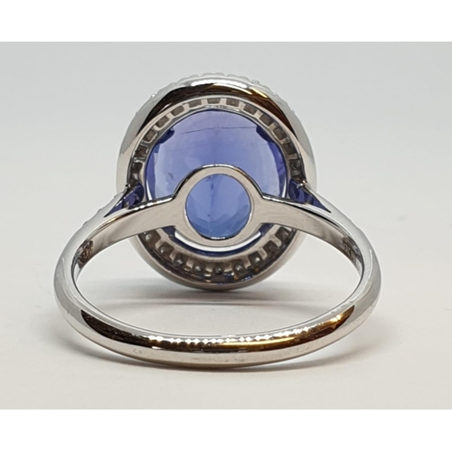 222 - 18ct white gold ring with 4ct tanzanite centre and encrusted diamond surrounding, weight 5.2g and si... 