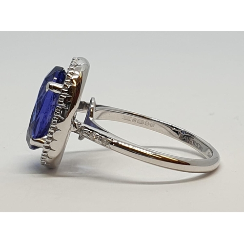 222 - 18ct white gold ring with 4ct tanzanite centre and encrusted diamond surrounding, weight 5.2g and si... 