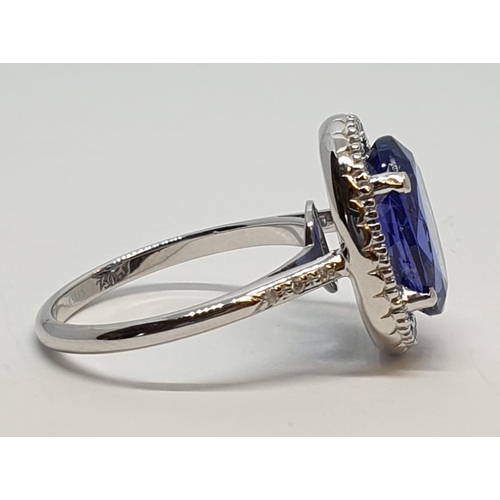 222 - 18ct white gold ring with 4ct tanzanite centre and encrusted diamond surrounding, weight 5.2g and si... 