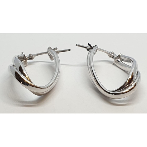 229 - 9ct White gold twist oval shaped hoop earrings. Weight 1.5g, Length 2.3cm