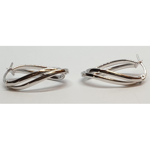 229 - 9ct White gold twist oval shaped hoop earrings. Weight 1.5g, Length 2.3cm