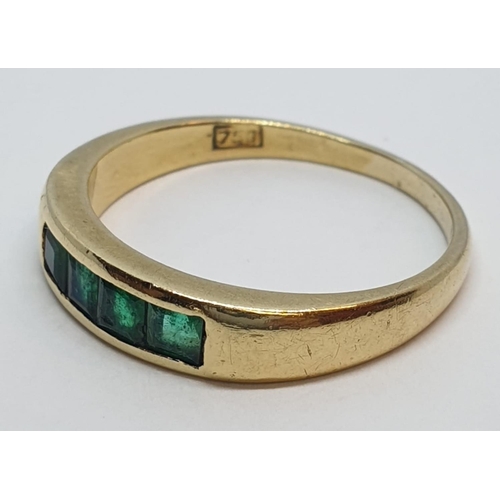 23 - 18ct Yellow gold emerald set band ring. Weight 3.8g, Size O.