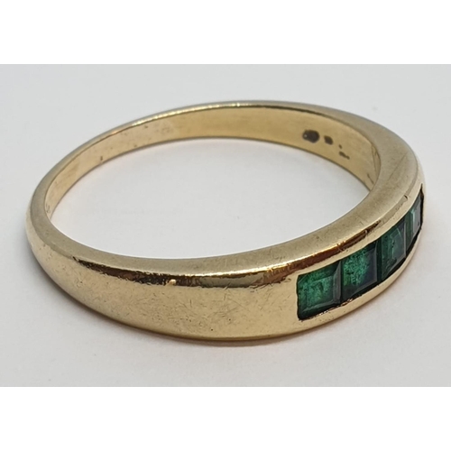 23 - 18ct Yellow gold emerald set band ring. Weight 3.8g, Size O.