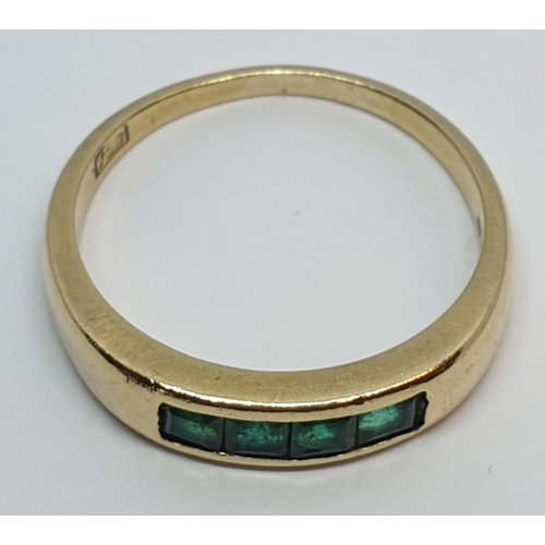 23 - 18ct Yellow gold emerald set band ring. Weight 3.8g, Size O.