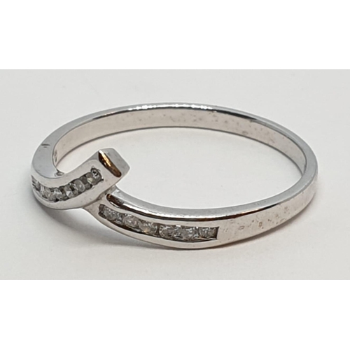 233 - 9ct White gold diamond set twist band ring. Weight 1.2g, Approx. 0.10ct of diamond, Size L.