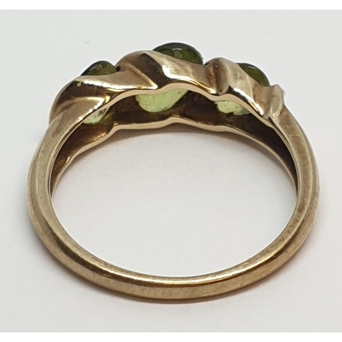 235 - 9ct Yellow gold three stone peridot ring. Weight 3g, Size P.