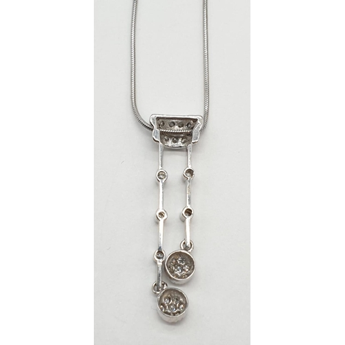 25 - 18ct White gold diamond set drop pendant on 18ct white gold snake chain. Weight 7.7g, Length 22cm.