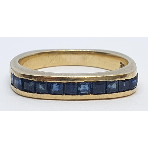 55 - 18ct Yellow gold sapphire set band ring. Weight 4.2g, Size K.