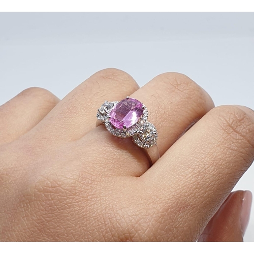 77 - 18ct white gold ring with 2.2ct oval pink sapphire centre and 0.50ct brilliant diamond on each shoul... 