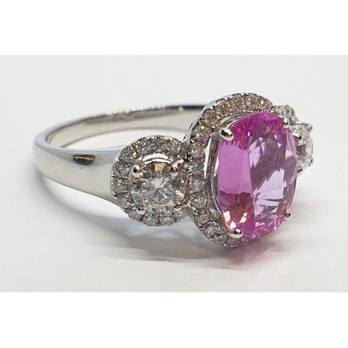 77 - 18ct white gold ring with 2.2ct oval pink sapphire centre and 0.50ct brilliant diamond on each shoul... 