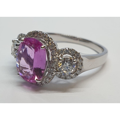 77 - 18ct white gold ring with 2.2ct oval pink sapphire centre and 0.50ct brilliant diamond on each shoul... 