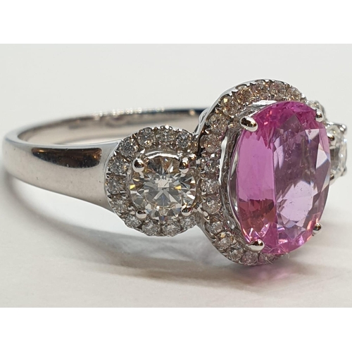 77 - 18ct white gold ring with 2.2ct oval pink sapphire centre and 0.50ct brilliant diamond on each shoul... 