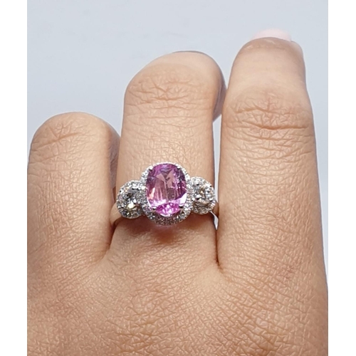 77 - 18ct white gold ring with 2.2ct oval pink sapphire centre and 0.50ct brilliant diamond on each shoul... 