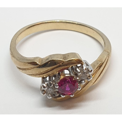 82 - 9ct Yellow gold three stone diamond and ruby ring. Weight 3g, Size N.