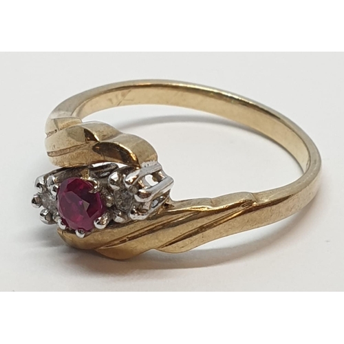 82 - 9ct Yellow gold three stone diamond and ruby ring. Weight 3g, Size N.